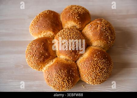 Challah bread rolls with sesame seeds, traditional Jewish food baked at Greek bakery on Ikaria island, Greece macro closeup Stock Photo