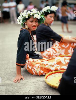 Philippines. Manila. Young Filipina women sitting with flower garlands on their heads. Stock Photo