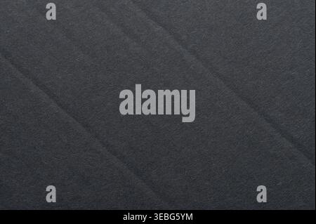 Black paper surface with crease line macro close up view Stock Photo