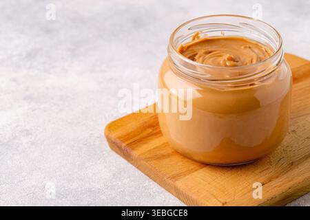 Peanut paste in an open jar Stock Photo