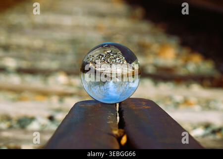 Glass Ball On Train Tracks Stock Photo