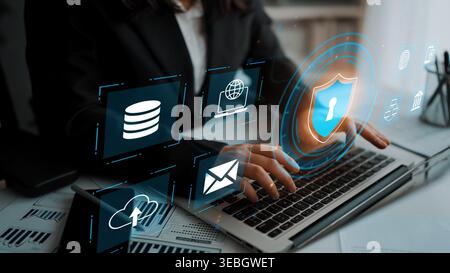 Modern Businesswoman Using Laptop with Cybersecurity Icons, Digital Security, Data Protection, and Cloud Technology Concept in Office Environment Stock Photo