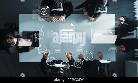 An aerial view of a business meeting showcasing professionals collaborating over documents, accompanied by digital icons symbolizing innovative data Stock Photo