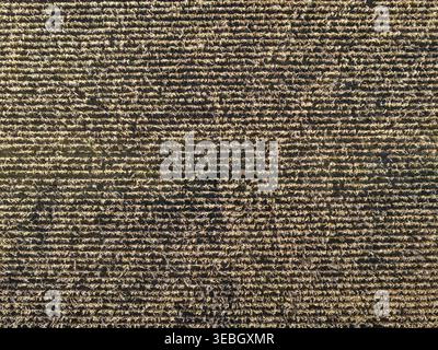 Close-up of a mottled mauve-brown textured wall or facade surface in Monroe Township, New Jersey. Stock Photo