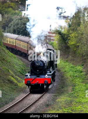British Railways Manor Class steam locomotive 7812 Erlestoke Manor, leaving Watchet Railway Station on the West Somerset Railway, Somerset, England Stock Photo