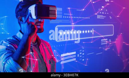 A young man explores a virtual reality world with a headset, surrounded by abstract digital graphics, symbolizing modern technology and immersive Stock Photo