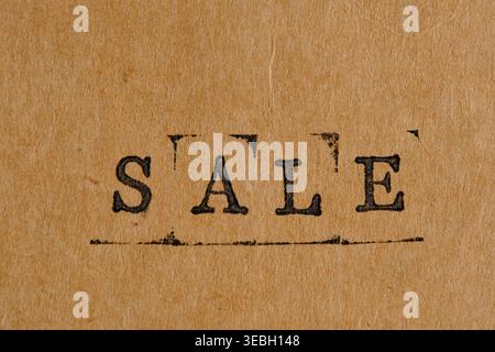 Vintage black SALE word stamped on old weathered paper background with ink texture Stock Photo
