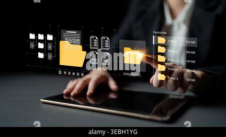A business professional interacts with a tablet, showcasing a digital interface for efficient file management and organization, emphasizing modern Stock Photo