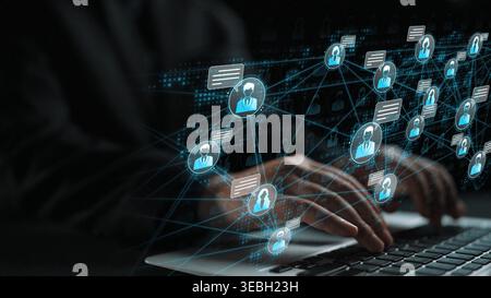 Hands of a businessman interacting with digital holographic network of people, symbols, and connections in a technological workspace environment Stock Photo