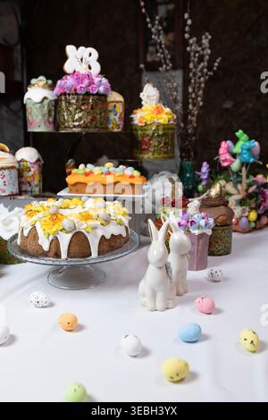 Variety of ornate Easter cakes with rich floral decoration on a tiered stand. Stock Photo