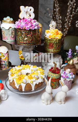 Variety of ornate Easter cakes with rich floral decoration on a tiered stand. Stock Photo