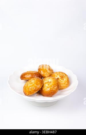 Freshly baked round buns with a glossy crust on an isolated white background. Stock Photo