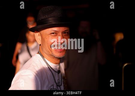 Hispanic middle aged man wearing a dark fedora hat and a white t-shirt on the Las Vegas strip on April 20, 2026 Las Vegas, Nevada Stock Photo