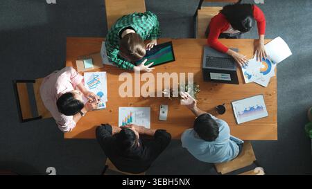 Time lapse of diverse business people working together to analyze chart. Top down aerial view of creative team looking at stock market report and Stock Photo