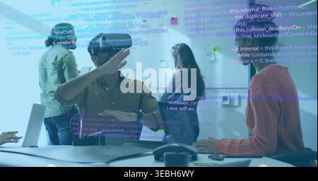 Demonstrating male wearing olive shirt and watch interacting with VR headset in glass-walled room Stock Photo