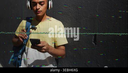 Checking striped man holding cell and backpack by textured darkgray wall headset glitch, copy space Stock Photo