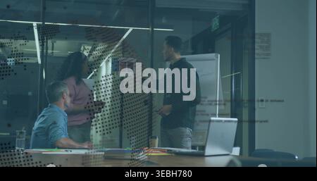 Discussing three in office clothes working around table in office with sticky notes on dotted glass Stock Photo