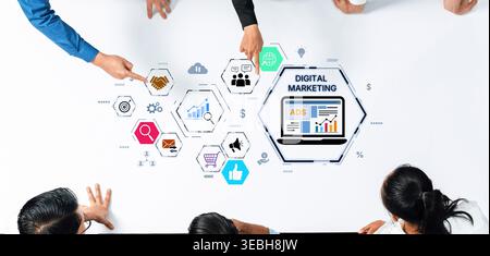 A team collaborates on digital marketing strategies, showcasing hands pointing at graphics, analytics, and advertising concepts on a white table Stock Photo