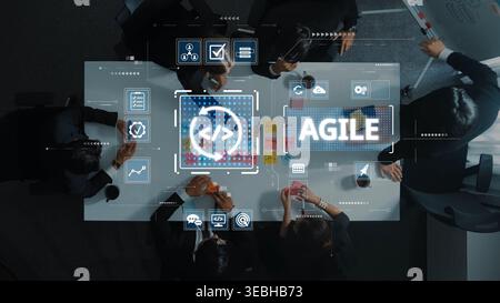 A top-down view of a business meeting focusing on agile software development, showcasing team collaboration with digital tools and project management Stock Photo