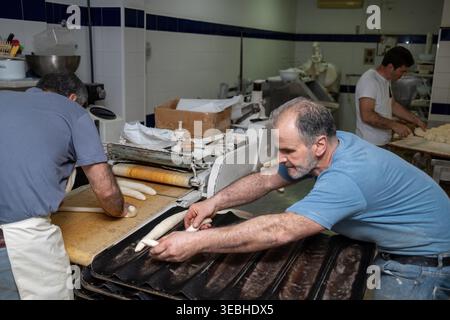 Bakers preparing bread dough in commercial kitchen Stock Photo
