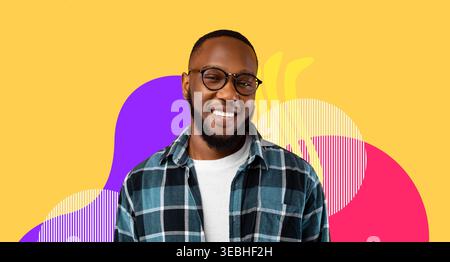 Cheerful Black Millennial Guy Smiles While Posing Against a Bright Yellow Background Stock Photo