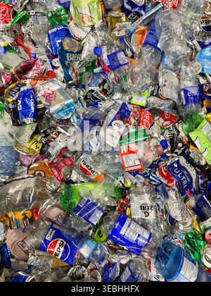 A collection of recyclable beverage containers, specifically crushed aluminum cans and plastic bottles. Stock Photo