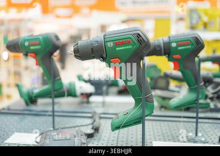 Bad Hersfeld, Germany, 04.21.2026: Electric drills displayed in hardware store with shallow depth of field. Focus on modern tools and blurred retail Stock Photo