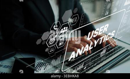 Professional Businessman Analyzing User Data on Laptop with Digital Graphic Interface for Insights and Improvements. Asymptotic smart data analytic. Stock Photo