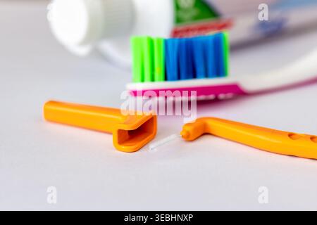 A close up of an angle interdental brush, a tooth brush and tooth paste isolated on white. Stock Photo