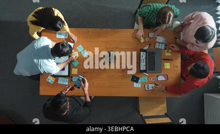Programmer team brainstorm and plan Ux Ui design for mobile phone while present idea by using laptop at meeting. Software developer look at wireframe Stock Photo