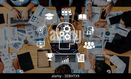 Collaborative Business Meeting with Data Analysis Charts and Graphs on a Table Surrounded by Professionals Working Together Gluon. Stock Photo
