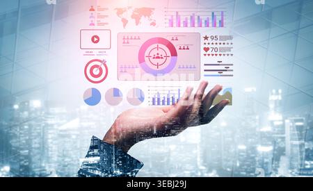 A hand holding a digital interface displaying various data visualizations including charts and metrics, symbolizing technology influence on business Stock Photo