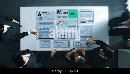 Team Collaboration on Data Analysis and Advertising Management Performance with Charts and Graphs Displayed on Table Quark. Stock Photo