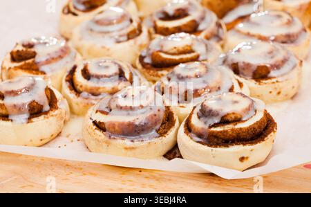 Cinnamon swirls on wooden background Stock Photo