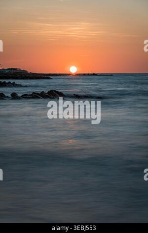 Vibrant sunset light reflecting on tranquil ocean water Stock Photo