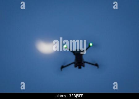 Drone flying during partial solar eclipse at sunset Stock Photo