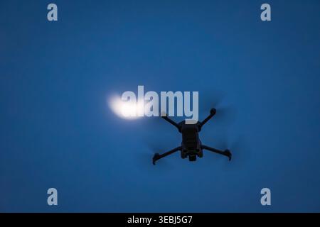 Drone flying during partial solar eclipse at sunset Stock Photo