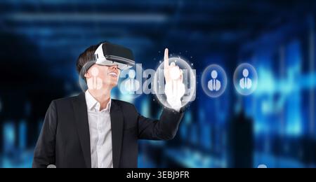A business professional enjoys a virtual reality experience, exploring networking opportunities with advanced technology and enhancing global Stock Photo
