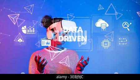 A user interacts with virtual reality technology while exploring data-driven insights and visualizations, highlighting the importance of analytics in Stock Photo