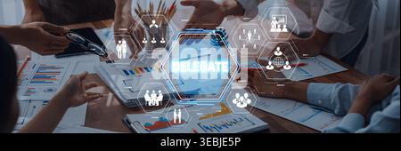 Hands of Diverse Business Team Collaborating on Project with Digital Delegate Concept and Various Graphic Icons at Modern Office Table Sigmoid Stock Photo