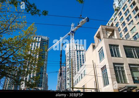 A building crane downtown in Vancouver, BC on a new condo development. Stock Photo
