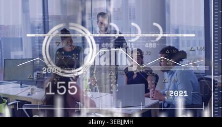 Presenting standing man in business shirt leading team in boardroom, laptop, overlays 155 2021 Stock Photo
