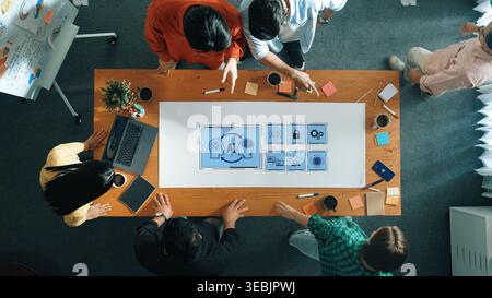 Diverse professionals engage in a collaborative team meeting focused on artificial intelligence solutions, discussing ideas and strategies with Stock Photo