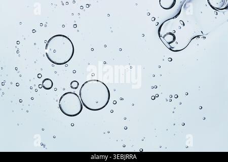 Golden skincare serum with gold flakes in glass dropper and petri dish on white background Stock Photo