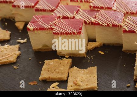 Dark slate background enhances the sweet treats' appeal. Crackers crumble slightly, adding rustic charm Stock Photo