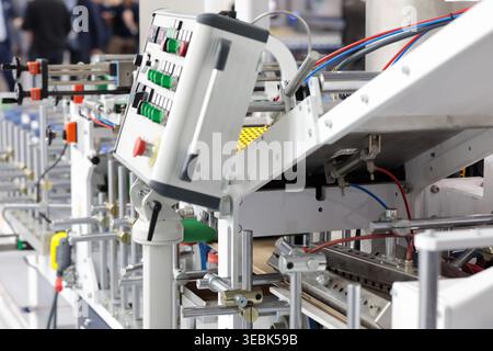 Automated industrial production line with control console. Selective focus. Stock Photo