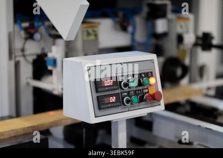 Close up of control console of industrial automated woodworking machine. Selective focus. Stock Photo