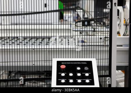 Industrial machinery with remote control console and safety fence. Selective focus. Stock Photo