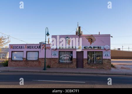 The pink storefront facade of the historic Joe and Aggie's Cafe along Route 66 under a clear blue sky in Holbrook, Arizona. Stock Photo