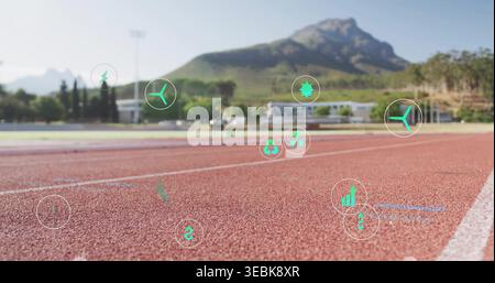 Displaying red synthetic track surface at outdoor athletics track, showing floating green eco icons Stock Photo